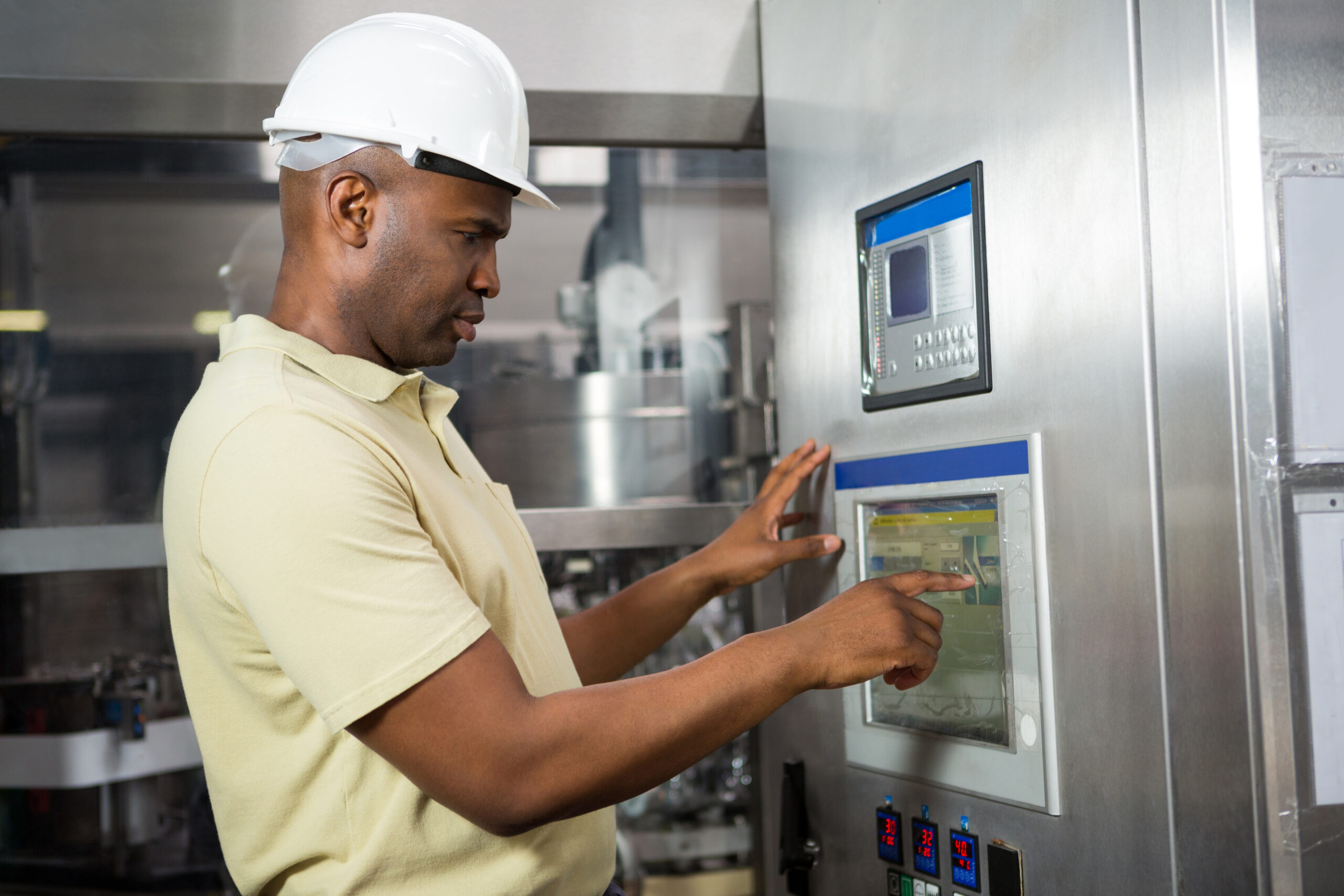 Maintenance technician operating industrial equipment during preventive servicing